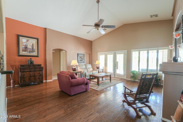 living room featuring dark hardwood / wood-style flooring, high vaulted ceiling, french doors, and ceiling fan