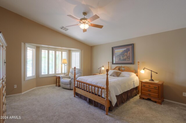 bedroom with ceiling fan, vaulted ceiling, and light carpet