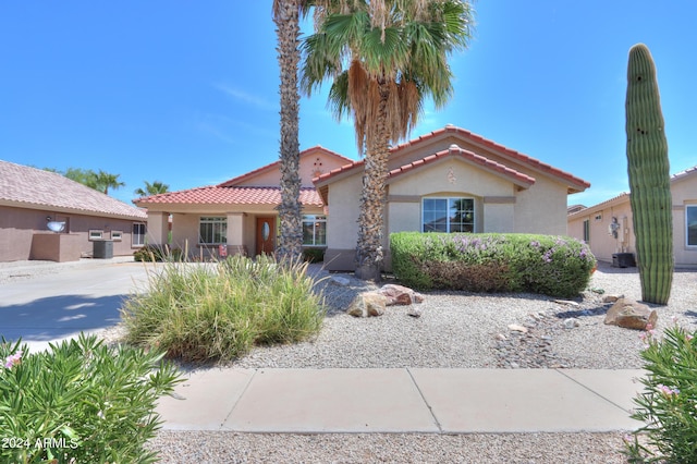 view of front of home with a tile roof and stucco siding