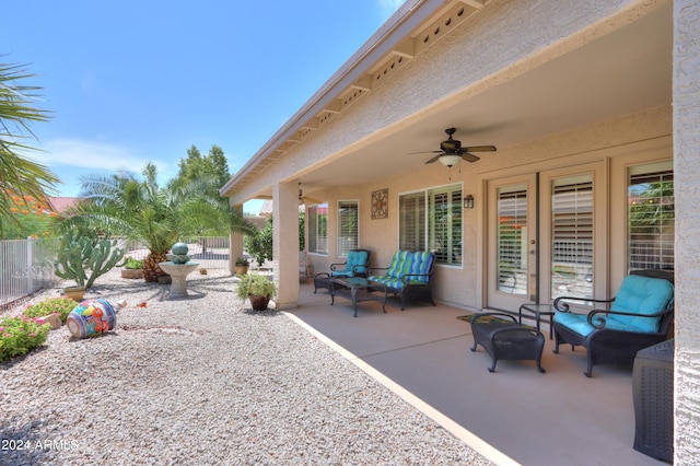 view of patio / terrace featuring ceiling fan, fence, and an outdoor living space