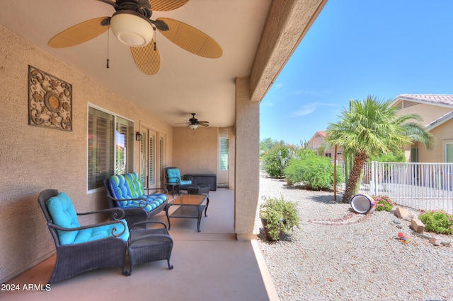 view of patio / terrace with fence, an outdoor living space, and a ceiling fan