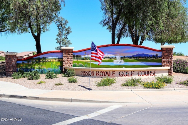 community sign featuring a water view