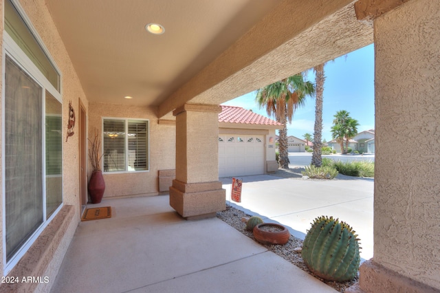 view of patio with driveway and an attached garage