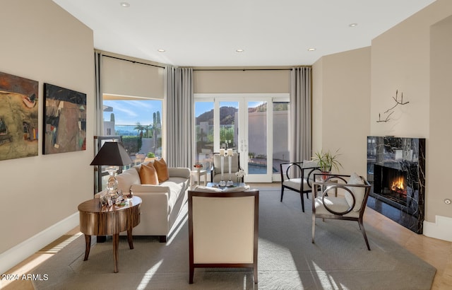 carpeted living room with french doors and a premium fireplace