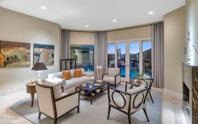 living room featuring a high end fireplace and french doors