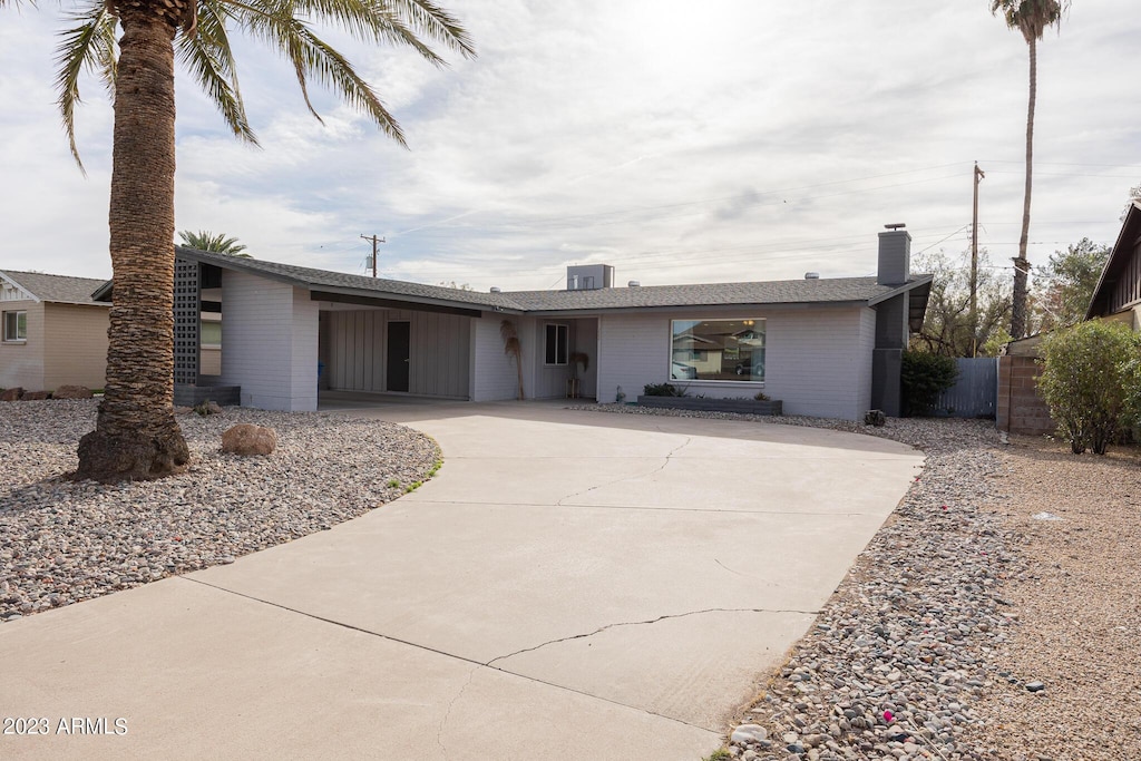 ranch-style house featuring cooling unit and a carport