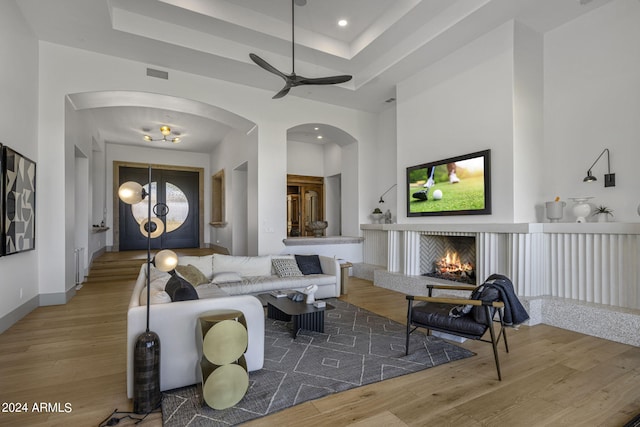 living room featuring ceiling fan and hardwood / wood-style floors