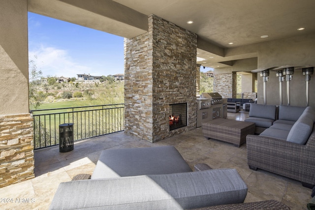 view of patio / terrace featuring an outdoor living space with a fireplace and a grill