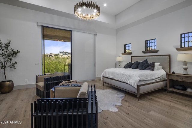 bedroom with a chandelier and hardwood / wood-style floors