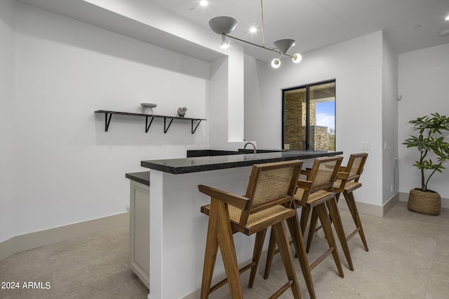 bar featuring hanging light fixtures