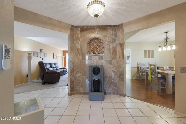 tiled living room featuring a textured ceiling