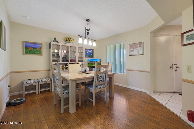 dining room with hardwood / wood-style floors and a textured ceiling