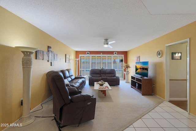 living room with ceiling fan, light colored carpet, and a textured ceiling