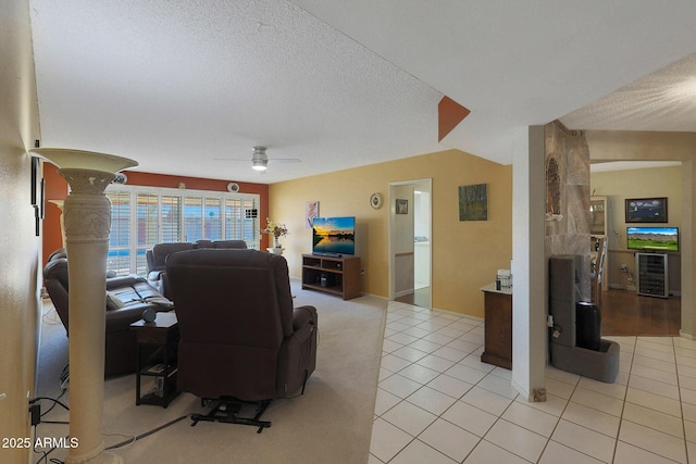 living room featuring ceiling fan, a textured ceiling, light tile patterned floors, and wine cooler