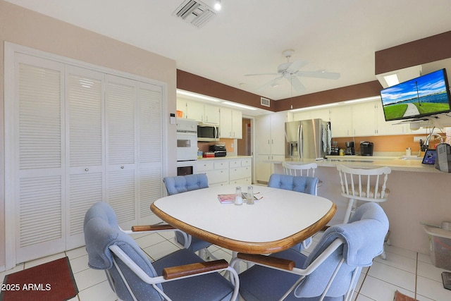 dining area with ceiling fan and light tile patterned floors