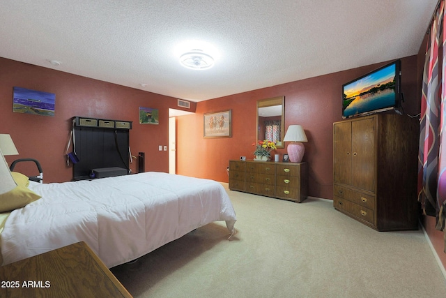 carpeted bedroom featuring a textured ceiling