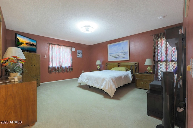 bedroom with a textured ceiling and light carpet