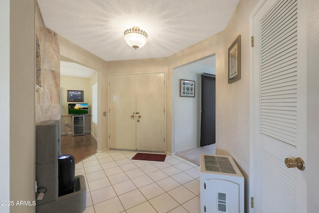 tiled foyer entrance featuring a textured ceiling