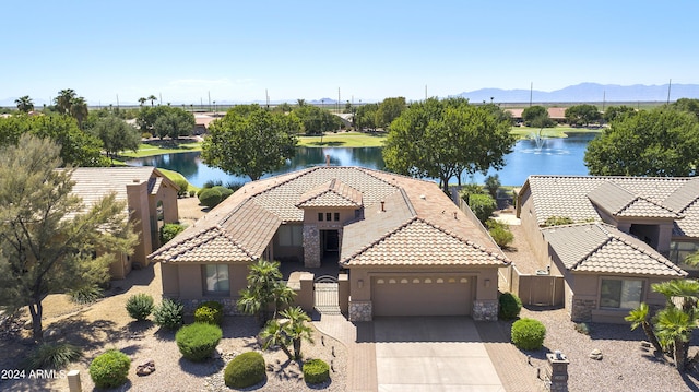 view of front of home with a water view and a garage