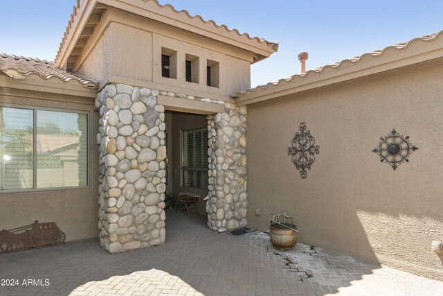 doorway to property featuring a patio