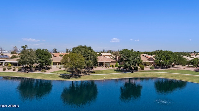 view of swimming pool featuring a water view and a yard