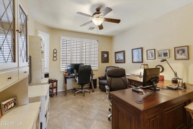 tiled home office featuring ceiling fan