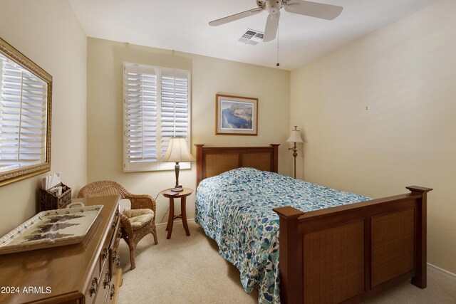 carpeted bedroom with multiple windows and ceiling fan