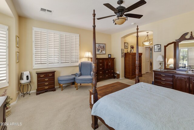 bedroom with ceiling fan and light colored carpet