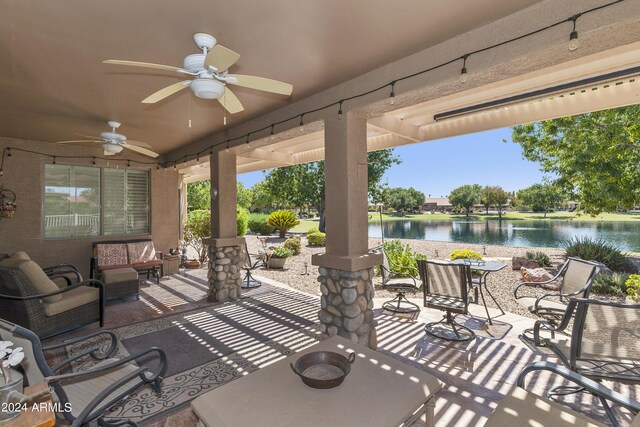 view of patio / terrace featuring a water view, ceiling fan, and an outdoor hangout area