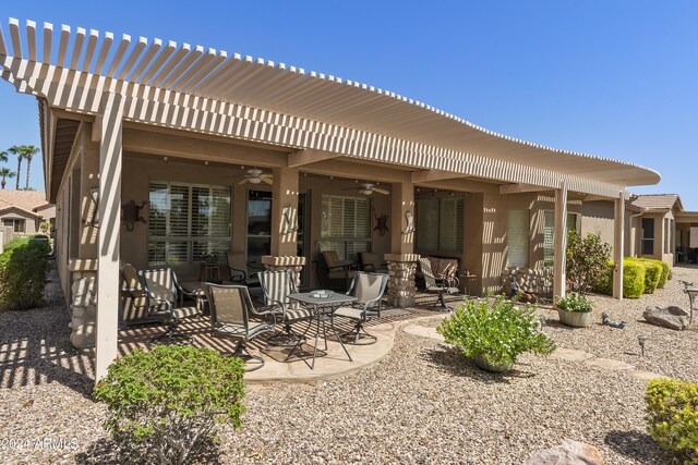 back of property with a pergola, ceiling fan, and a patio area