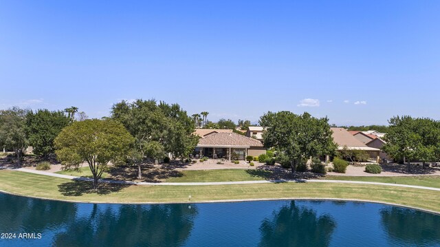 view of swimming pool with a lawn and a water view