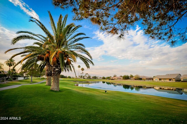 view of community featuring a lawn and a water view