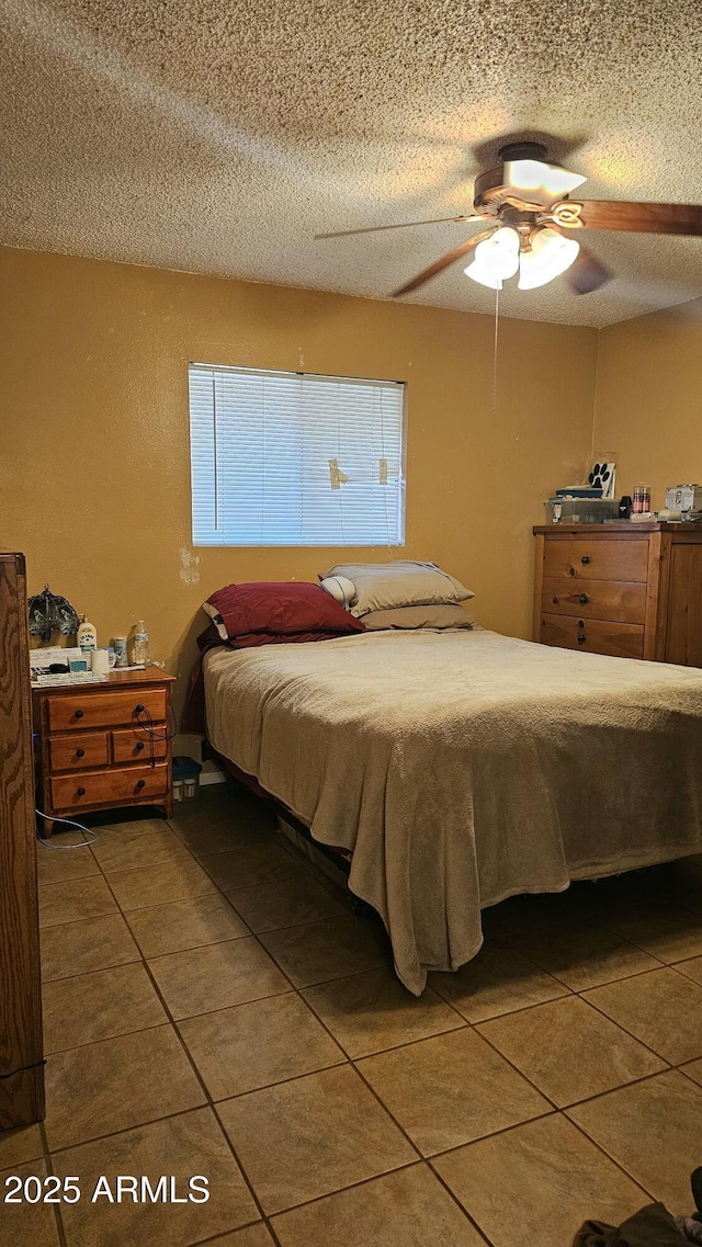 265 W 17th Ave, Apache Junction, AZ 85120 - bedroom featuring tile patterned floors, a textured ceiling, and ceiling fan