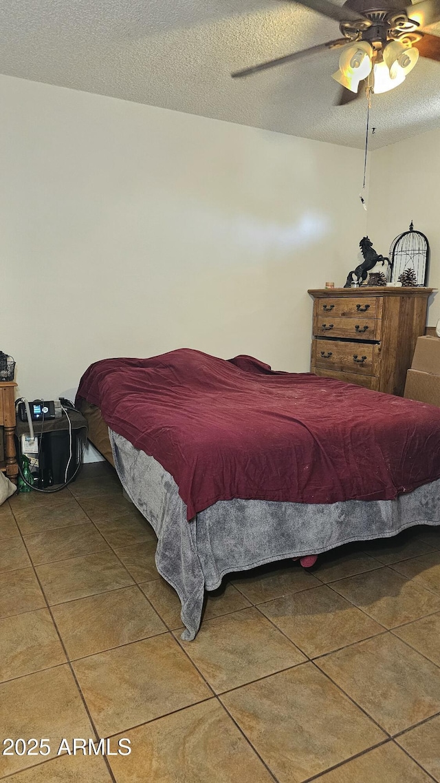265 W 17th Ave, Apache Junction, AZ 85120 - tiled bedroom with a textured ceiling and ceiling fan