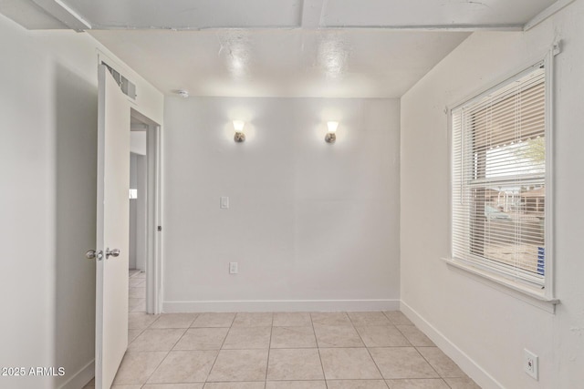 unfurnished room featuring light tile patterned floors