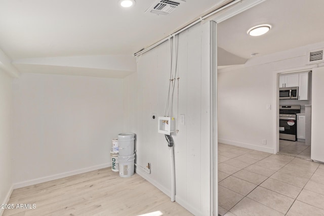 clothes washing area with hookup for an electric dryer, light hardwood / wood-style floors, and hookup for a washing machine