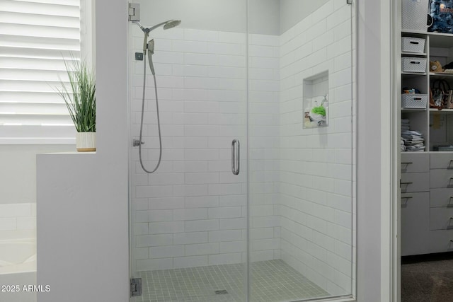 full bathroom featuring a stall shower and a bath