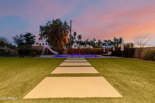 view of property's community featuring a yard, a pool, and fence