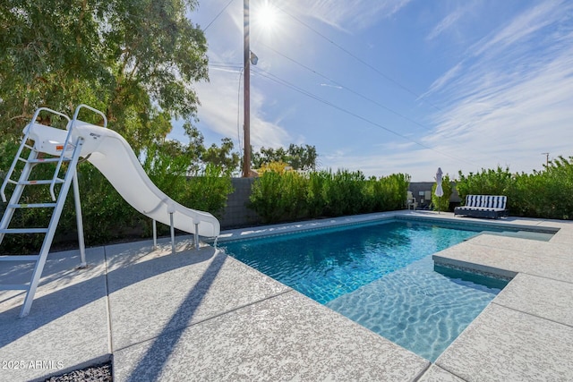 view of swimming pool with a patio, a water slide, a fenced backyard, and a fenced in pool