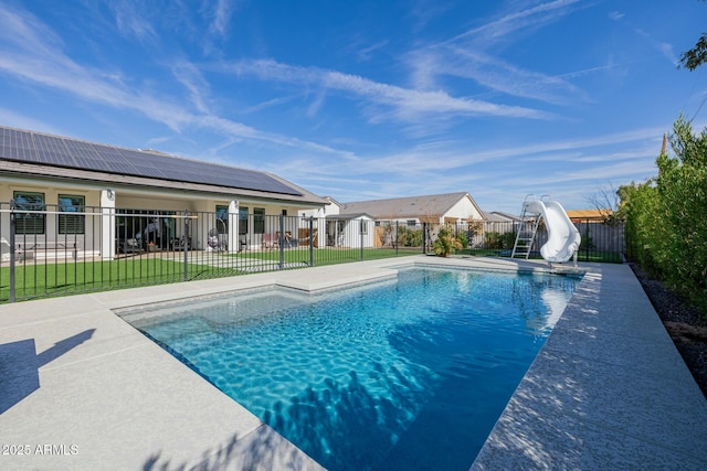 view of pool with a fenced in pool, a lawn, a patio area, a water slide, and a fenced backyard