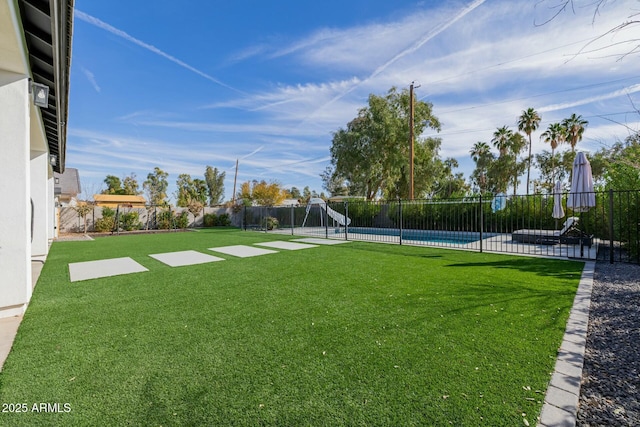 view of yard with a fenced in pool and a fenced backyard