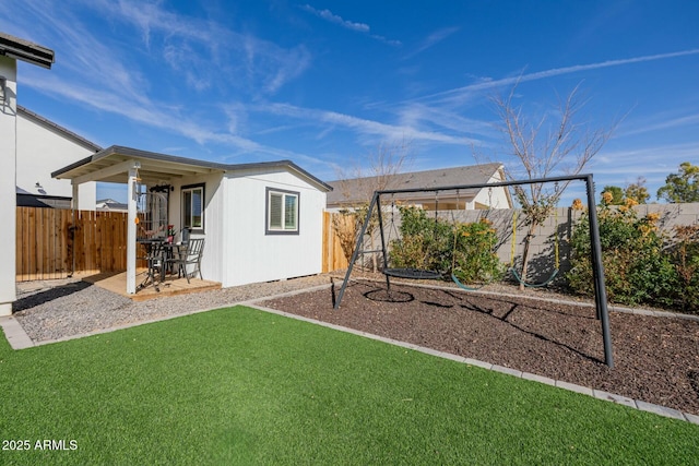 exterior space with a fenced backyard and an outbuilding