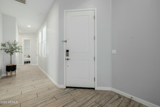 entrance foyer with recessed lighting, baseboards, and light wood finished floors