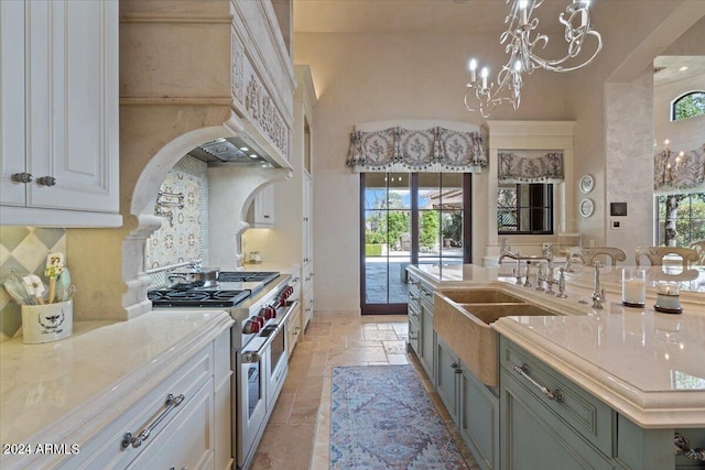 kitchen with light stone countertops, double oven range, and plenty of natural light