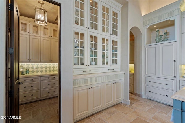 interior space with pendant lighting and backsplash