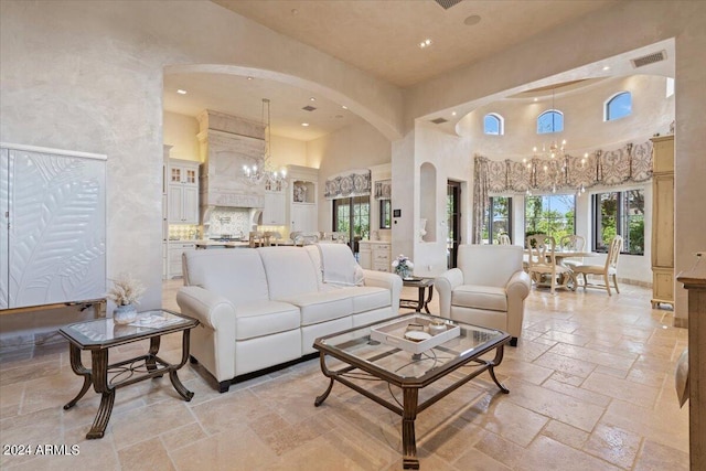 living room featuring a towering ceiling and an inviting chandelier