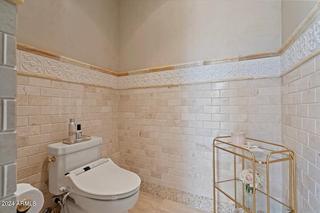 bathroom with toilet and tile walls