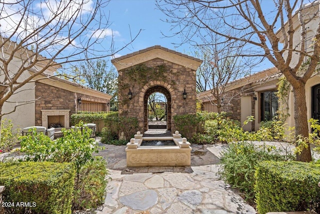 view of patio / terrace with an outdoor stone fireplace