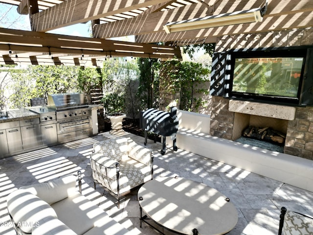 view of patio with an outdoor living space with a fireplace, a pergola, area for grilling, and grilling area