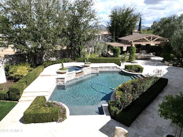 view of swimming pool with an in ground hot tub and a patio area